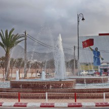 Fountain in Sidi Ifni with a fighting woman in the back